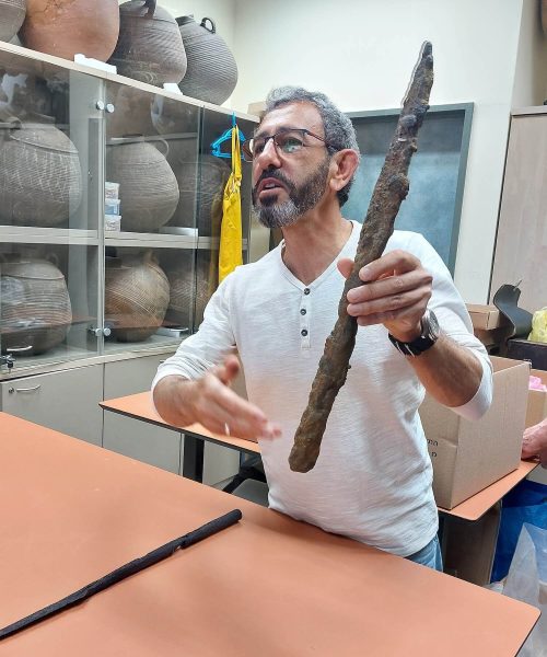 Michael Eisenberg of the Haifa University Department of Archaeology, showing a Byzantine sword from the mid - 5 th century CE . ( Photo by M. van den Berg)