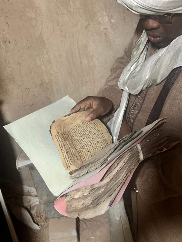A librarian shows us a manuscript to be digitized from a private library in Algeria. Photo courtesy of Abir Chorfa.