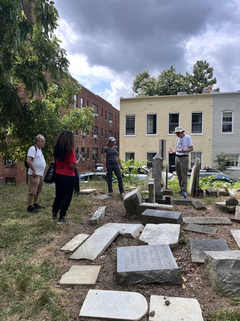 ASOR staff and participants discuss how to document a tombstone.