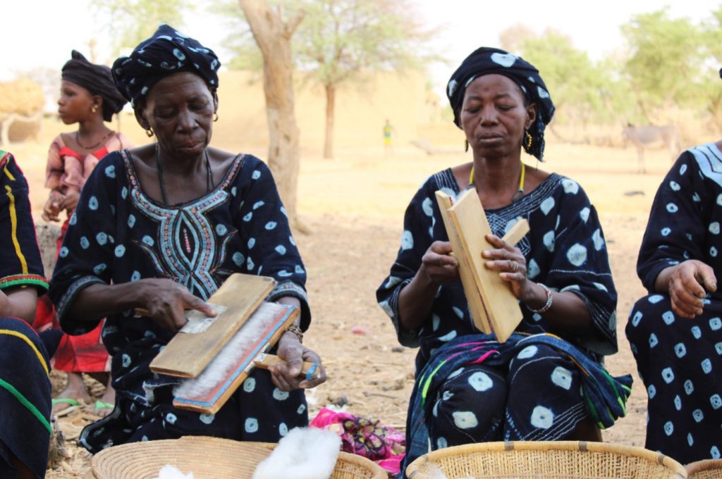 Step 2: Cleaning and straightening cotton using two carding boards; Photo Credit: ADI/ASOR