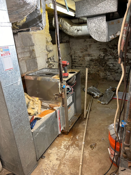 Removing old HVAC units from the basement of the Strange Center.