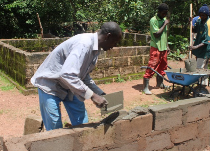 A member of the Muslim community restoring an animist grave. Photo Credit: AESPAT/ASOR.