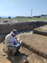 Rubar Yavuz taking notes at Tell Tayinat, Turkey. 