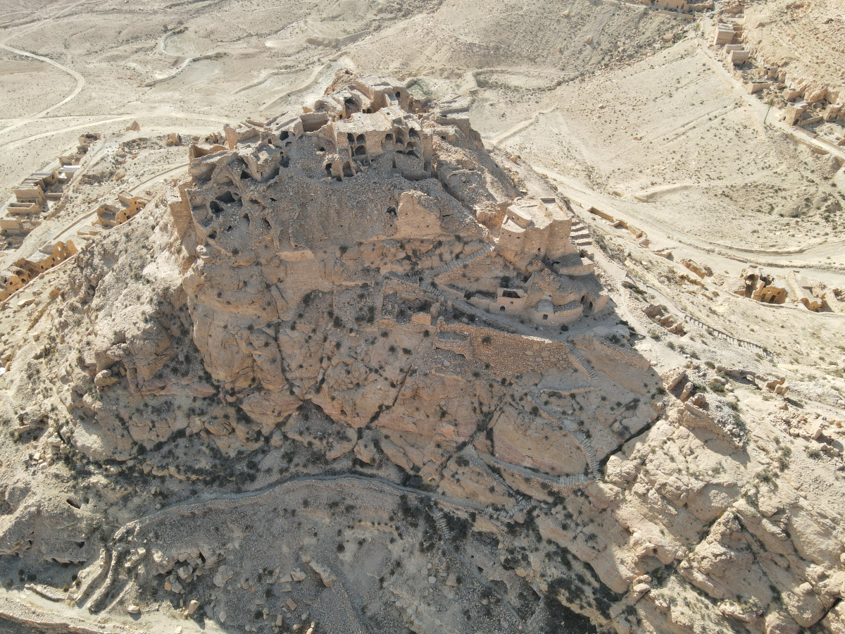 Drone photograph of the ksar with the primary pathway visible in the shadow in the middle of the image. Photo Credit: ASOR.